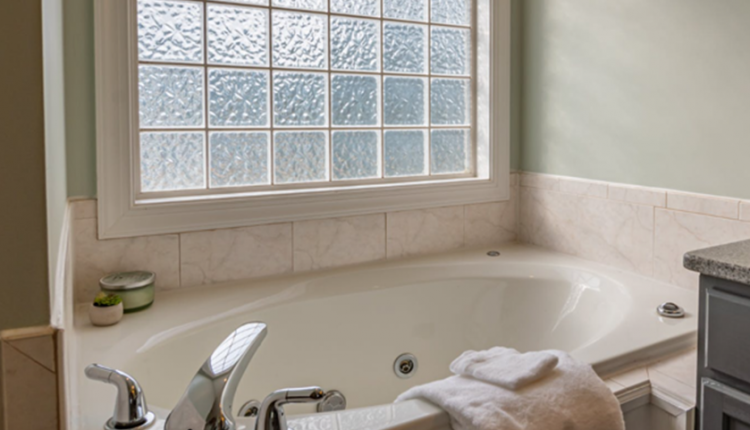 bathroom with ceramic bathtub